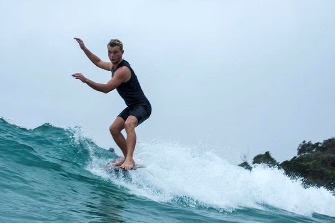 A man surfing on a wave.