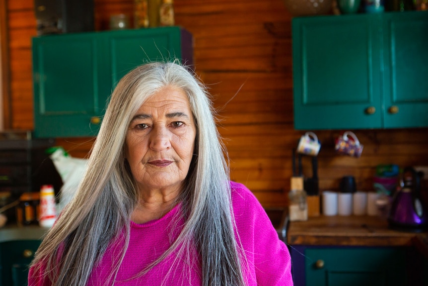 A middle aged woman in her kitchen.