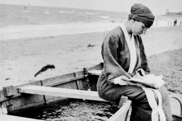 Woman reading on a boat SLQ 1925