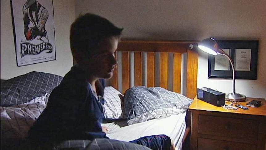 A sleepy teenager in his bedroom