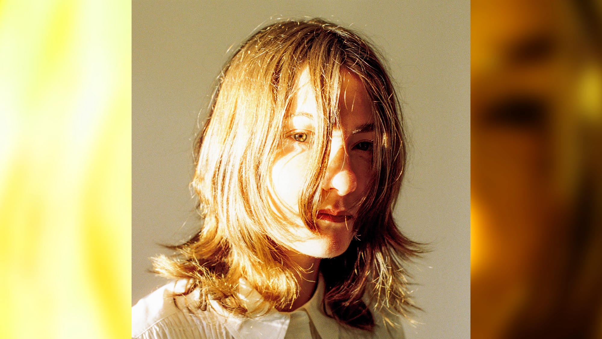Portrait of brunette woman in her early 30s, hair hanging , the light exposure blows out her hair and features to surreal degree