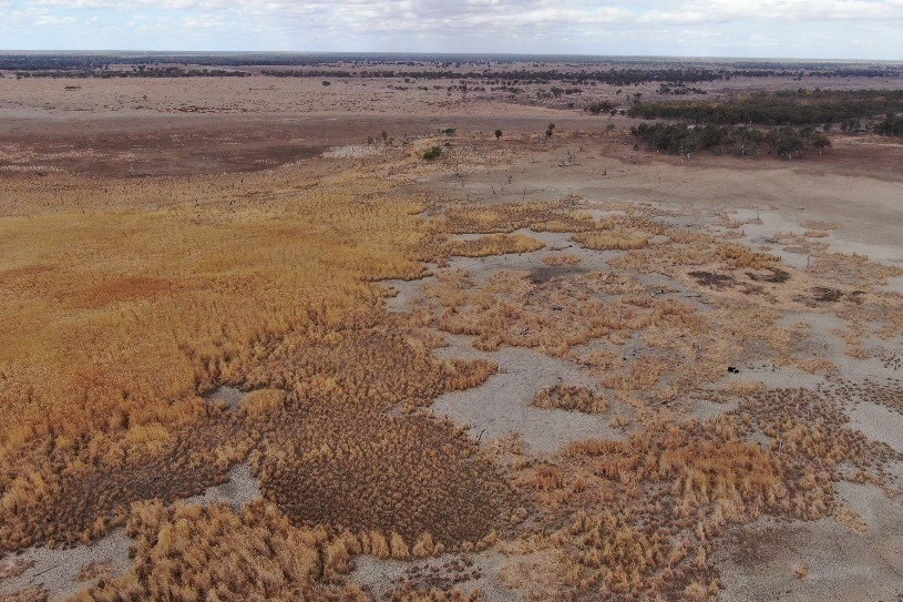 A brown landscape of dry land and empty lakes taken from the area.