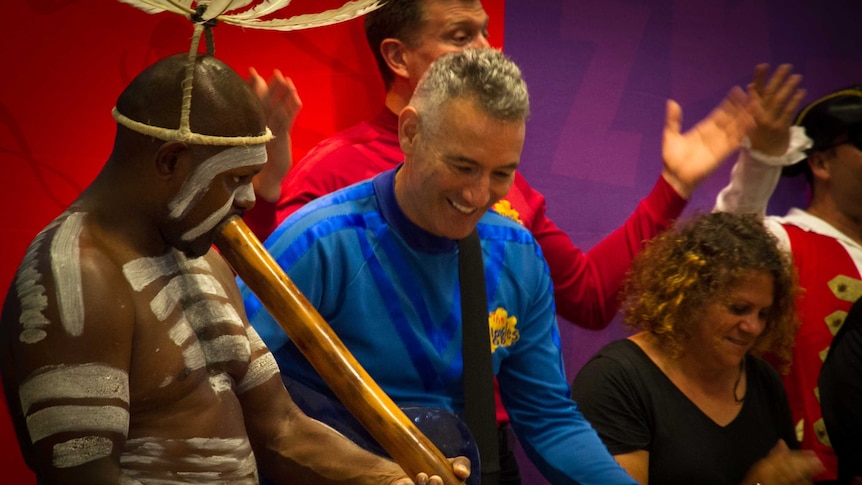 Anthony the Blue Wiggle dance with Nathan Schreiber, who is in traditional indigenous dress.
