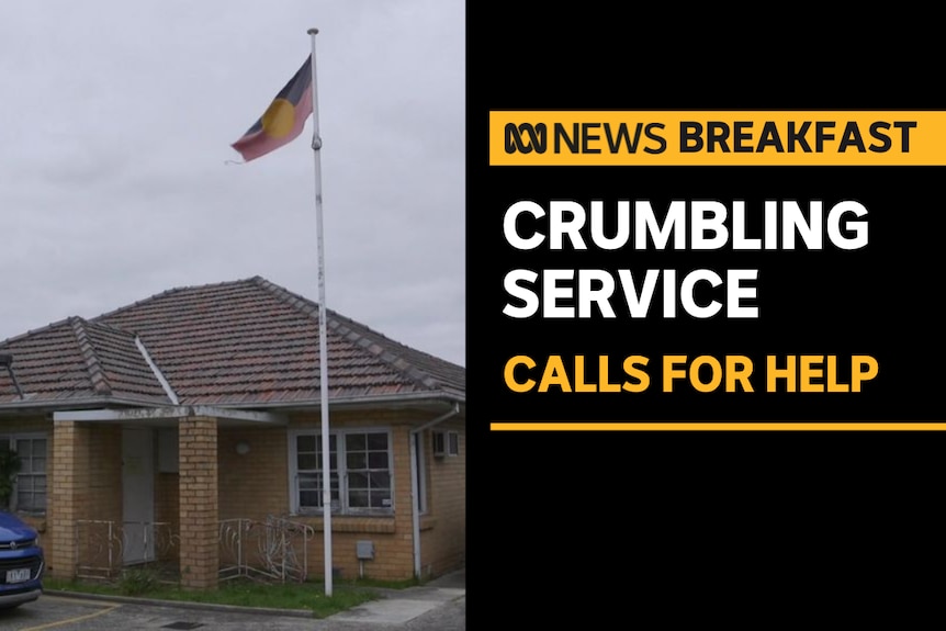 Crumbling Service, Calls For Help: Blonde brick service centre flying Aboriginal flag.