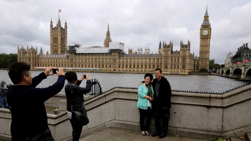 Chinese tourists take pictures near the Big ben clock tower in London, Britain June 29, 2016.