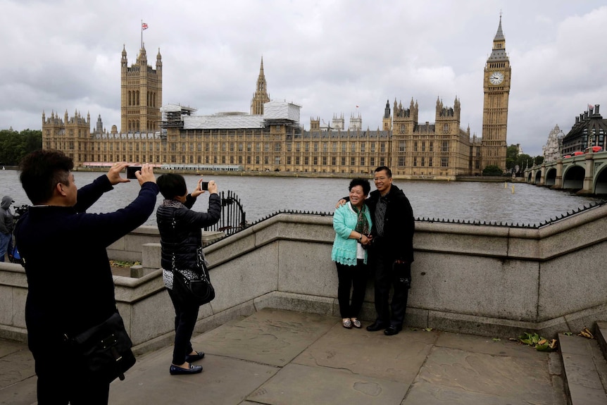 Chinese tourists take pictures near the Big ben clock tower in London, Britain June 29, 2016.