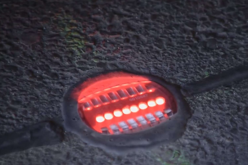 An in-ground traffic light in Augsburg, Germany, flashes red.