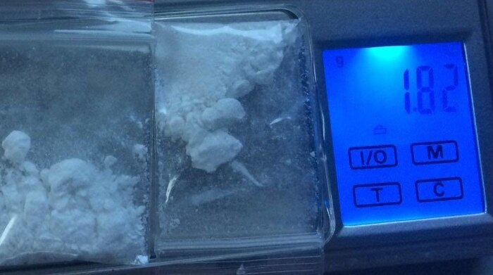 Two small plastic bags containing a white powder substance sitting on micro scales