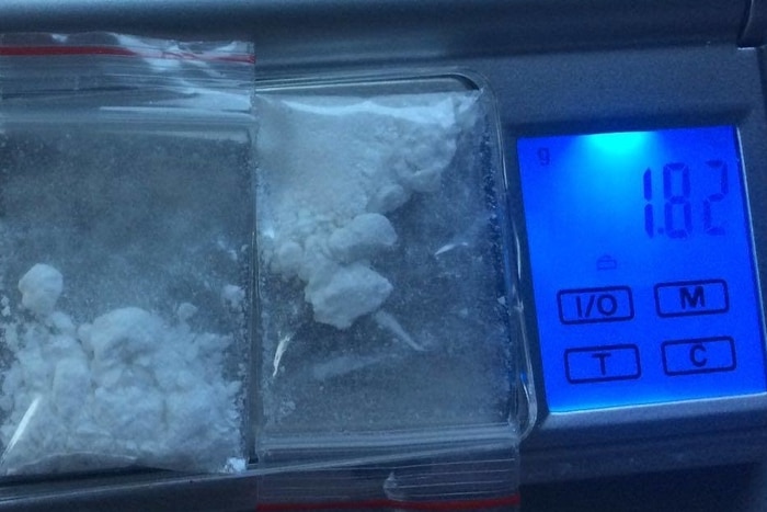 Two small plastic bags containing a white powder substance sitting on micro scales