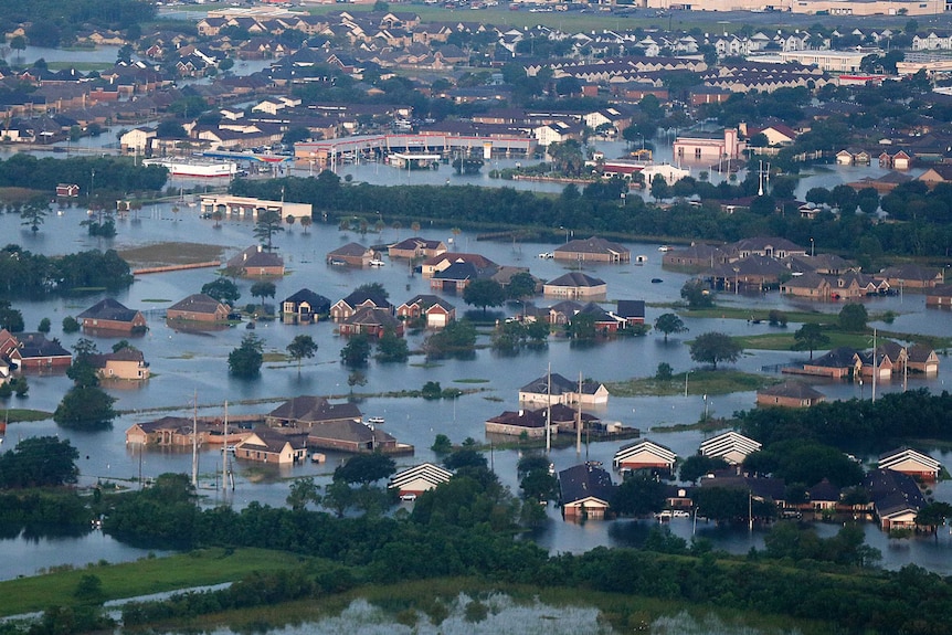 Floodwaters from Tropical Storm Harvey surround homes and businesses.