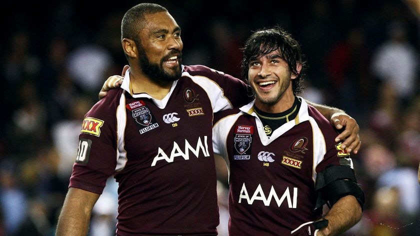 Qld players Petero Civoniceva and Johnathan Thurston celebrate after winning game one