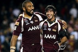 Qld players Petero Civoniceva and Johnathan Thurston celebrate after winning game one