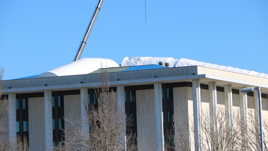 Large white plastic wrapped over repairs on roof of National Library in Canberra.