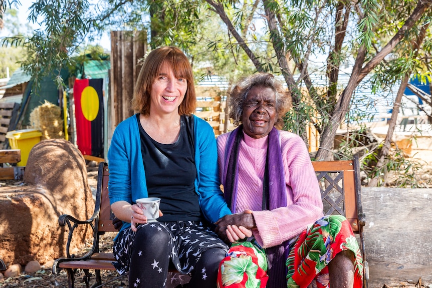 Purple House chief executive Sarah Brown sits with one of their patients, Rosie, outside their dialysis unit in Kintore.