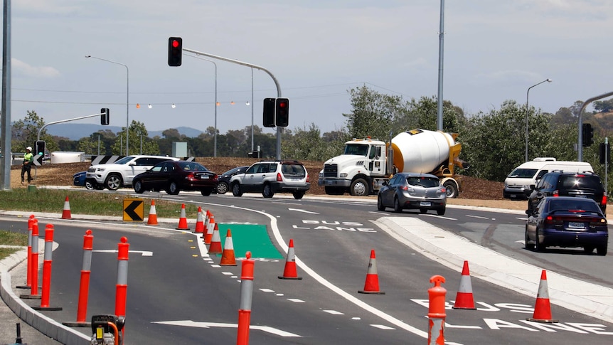 Cars travelling around the Barton Highway roundabout, now with traffic lights.
