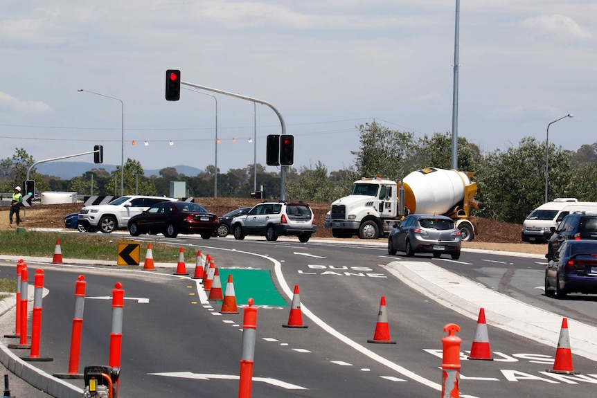 Cars travelling around the Barton Highway roundabout, now with traffic lights.