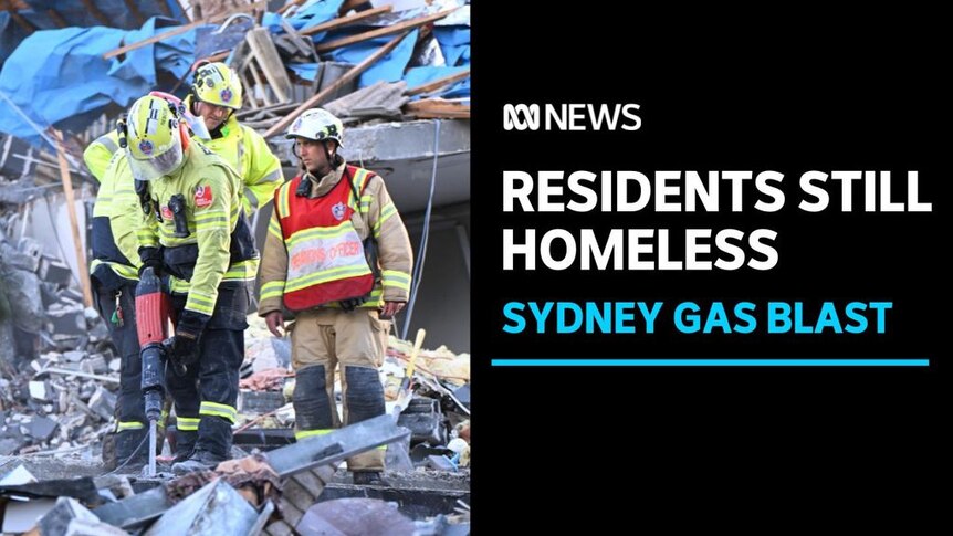 Residents Still Homeless, Sydney Gas Blast: An emergency worker jackhammers through rubble while two others stand by.