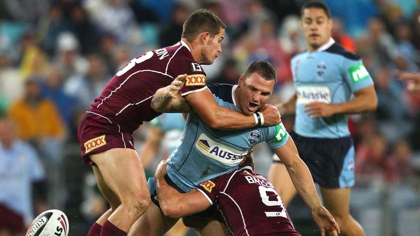 Queensland scored two tries to one in a first half dictated primarly by the sodden conditions.