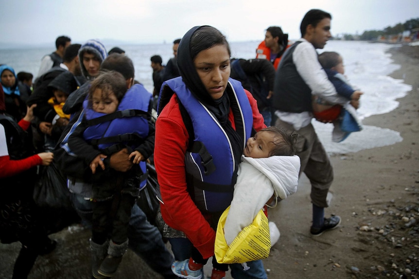 Afghan immigrants land at a beach on the Greek island of Kos