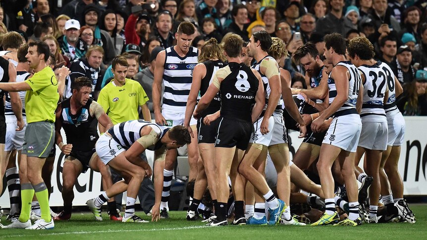 Port Adelaide, Geelong players wrestle after quarter-time siren at Adelaide Oval.