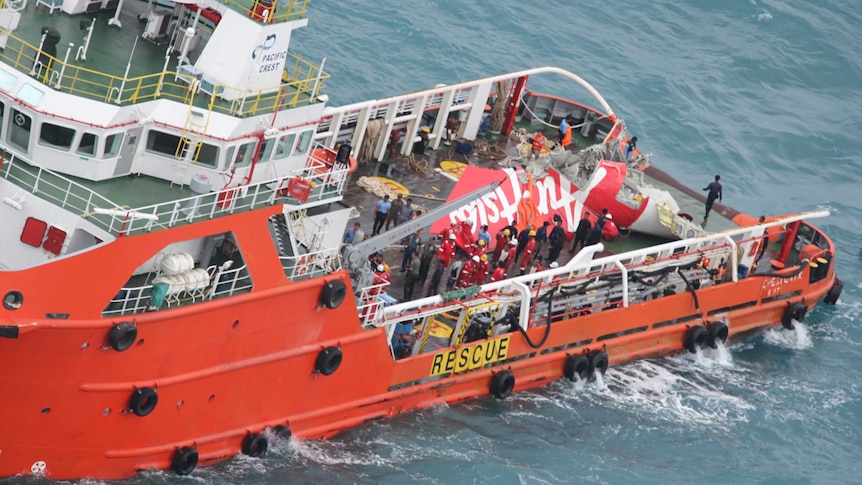 A supply ship carries the tail of Air Asia flight QZ8501, recovered from the sea floor