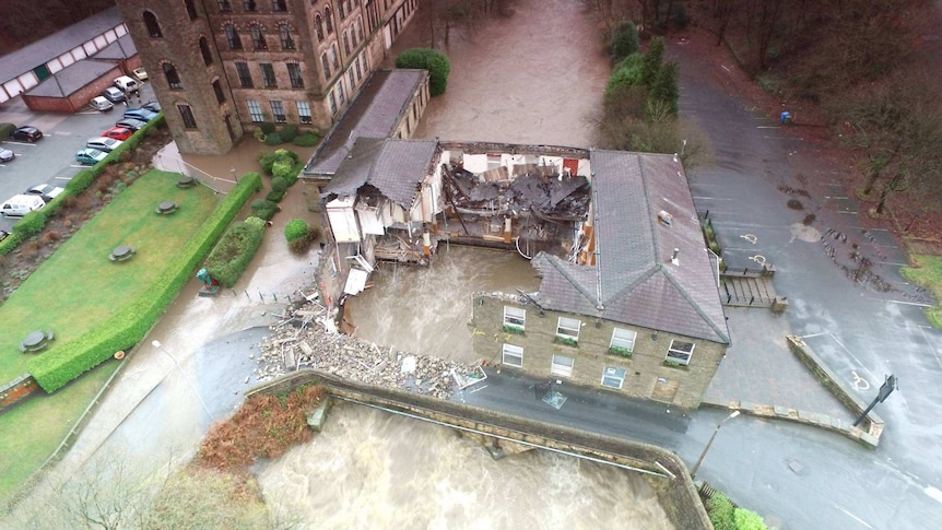 Water washes through the collapsed Summerseat Pub.