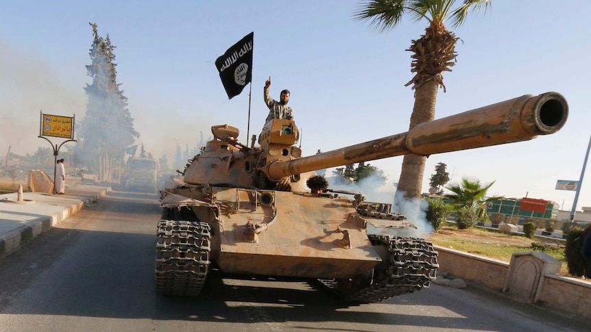 An Islamic State militant on top of a tank in Syria's northern Raqqa province.