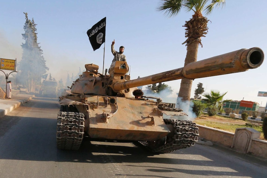 An Islamic State militant on top of a tank in Syria's northern Raqqa province.