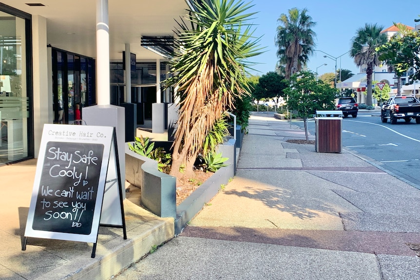 A sign outside a salon saying "Stay safe Cooly, we can't wait to see you soon".