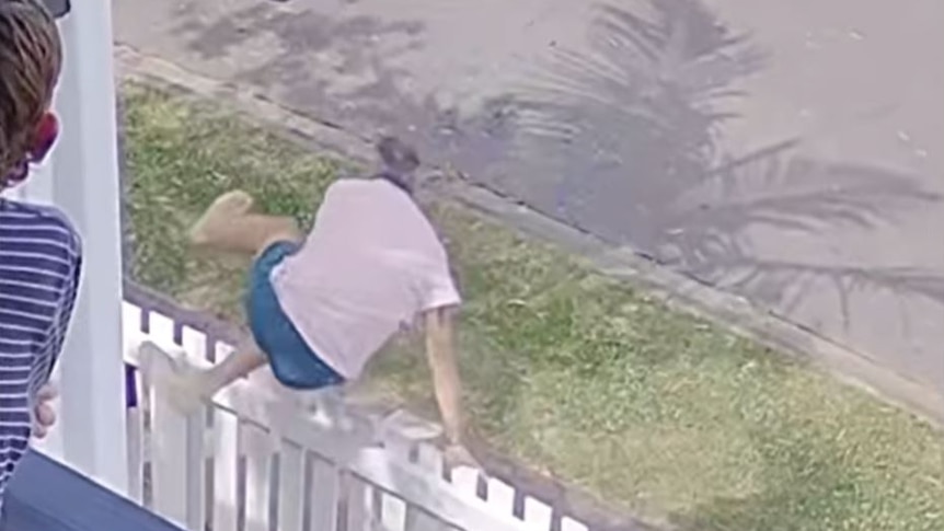 A man jumping over a picket fence