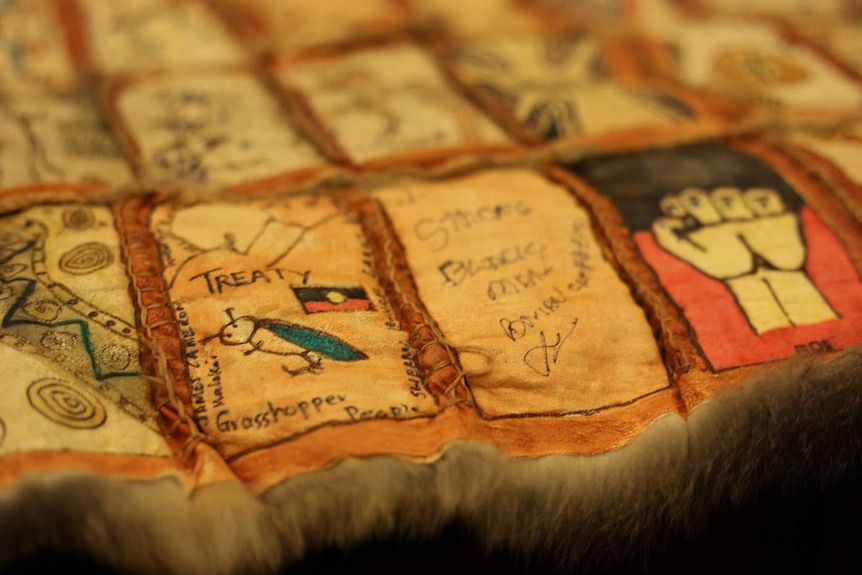 A possum-skin quilt built from squares etched with messages about the promise of the treaty process.