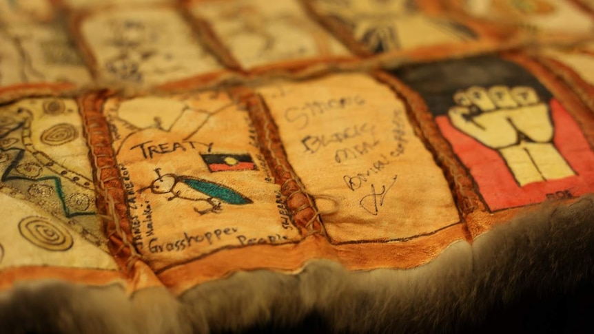 A possum-skin quilt built from squares etched with messages about the promise of the treaty process.