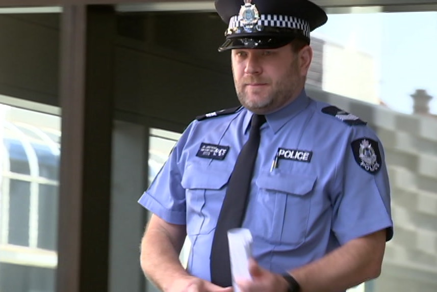 A police officer outside a court.