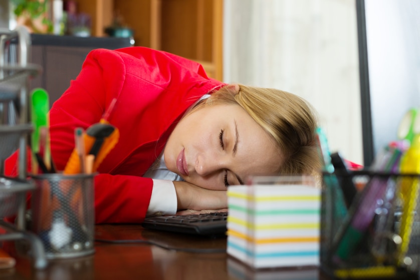 A woman at work who has fallen asleep at her desk