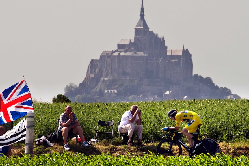 Chris Froome rides past spectators during the stage 11 time trial of the Tour de France.