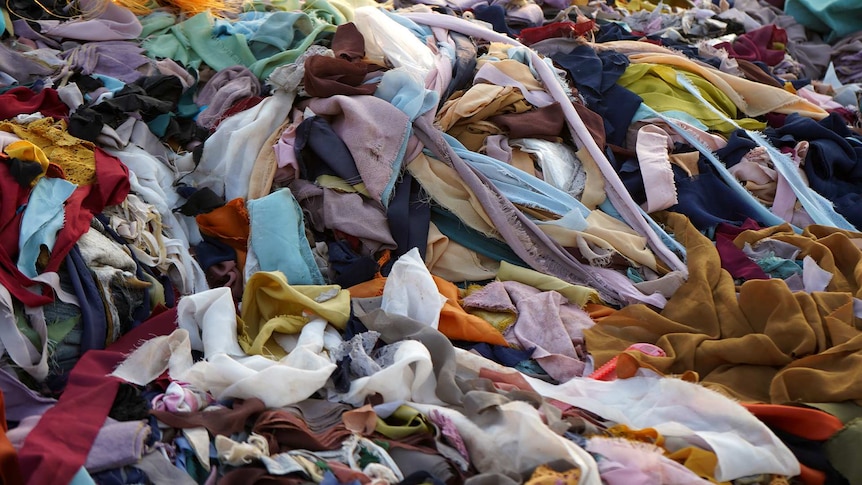 piles of textiles in landfill