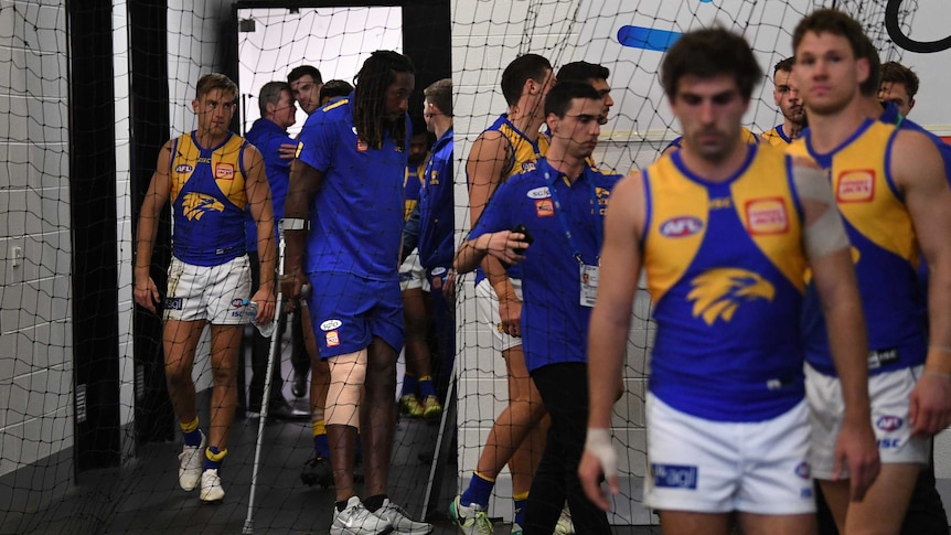 Nic Naitanui on crutches in the MCG rooms after injuring his knee.