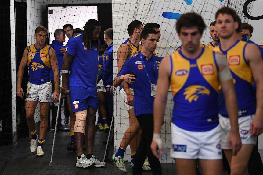 Nic Naitanui on crutches in the MCG rooms after injuring his knee.