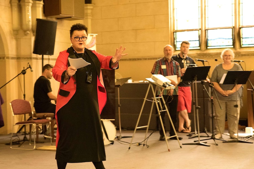 Reverend Sue Wickham gives a sermon inside the church.