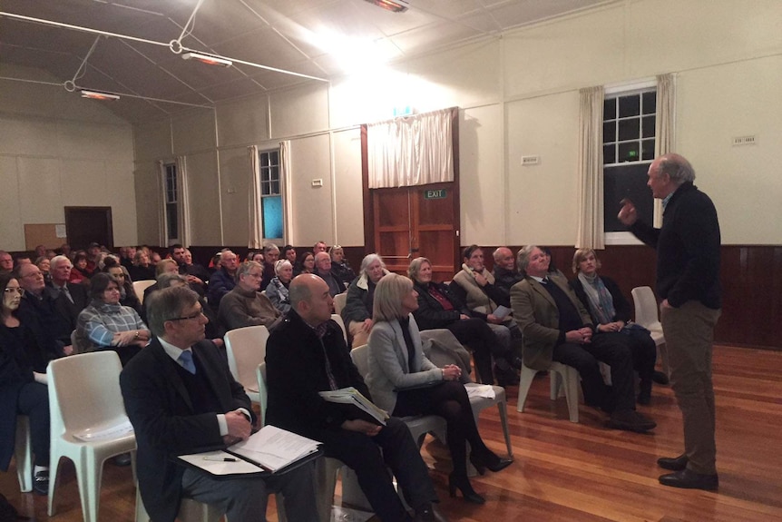 Ron Sonners talks to concerned parishioners about the sale of the Anglican Church