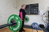 Barbara Collins, 81 lifting over 20 kilogram weights.