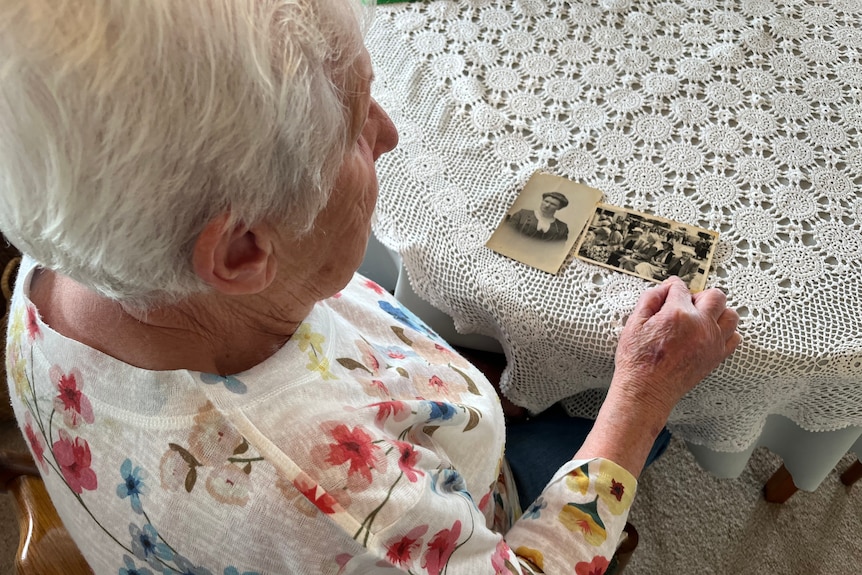 A woman looks at old photos