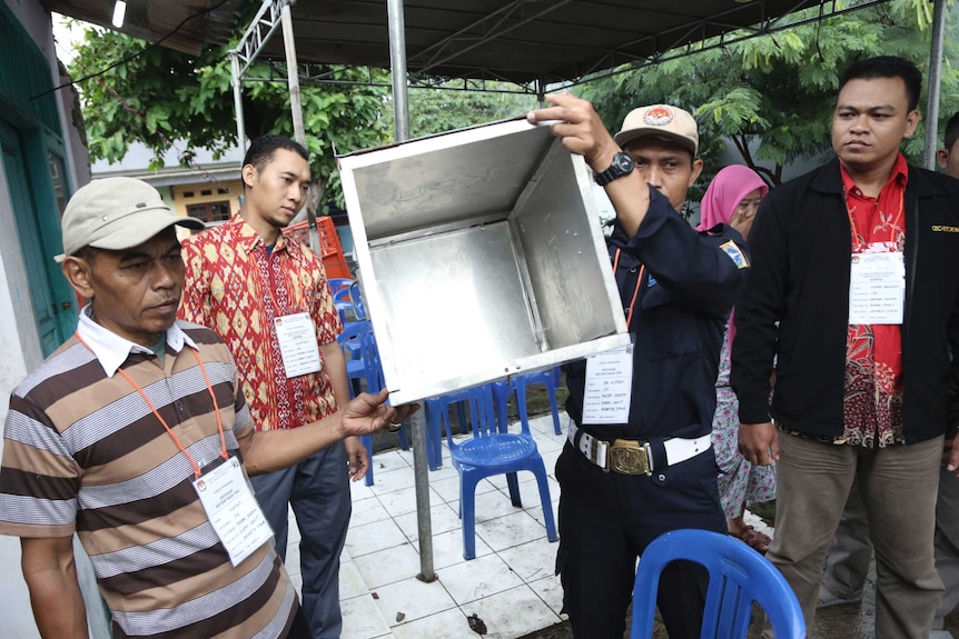 Electoral workers at a Jakarta polling station the election for governor of the Indonesian capital.