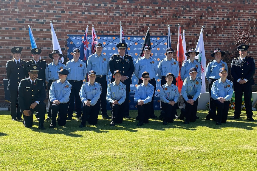 Group Photo of Emergency Service Personnel and Cadets gathered in front of the a