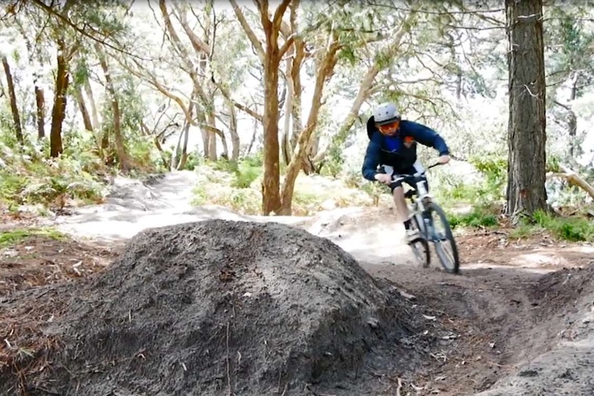 A mountain bike rider taking a corner.