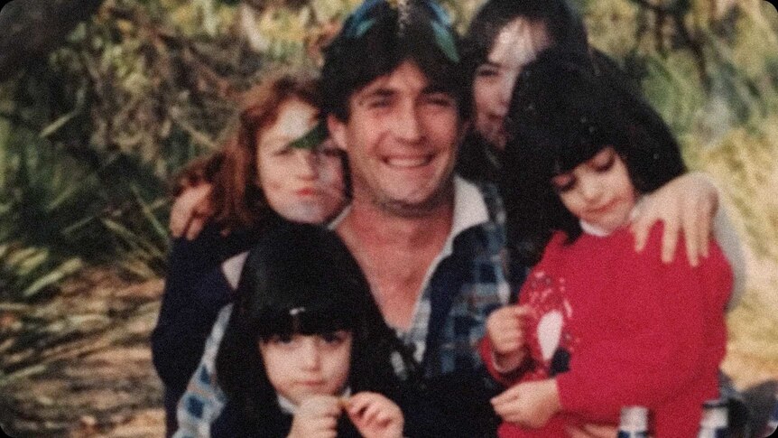 Old photo of David with his daughters.