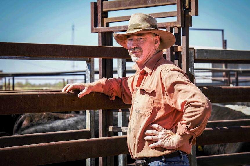 Grazier Peter Whip leans against a cattle run on his property near Longreach in Queensland.