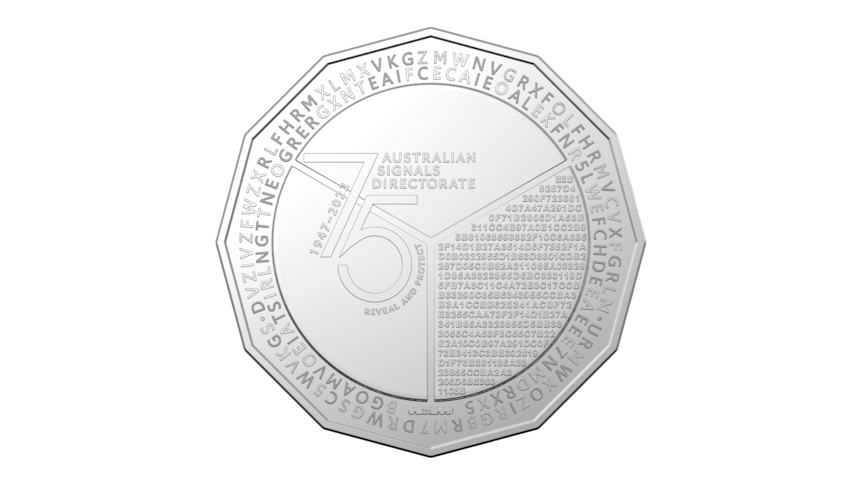 A silver coin with many small letters and numbers arranged on it.