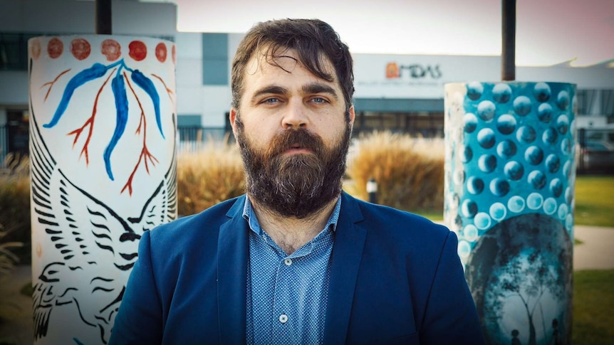 Bearded man outside building