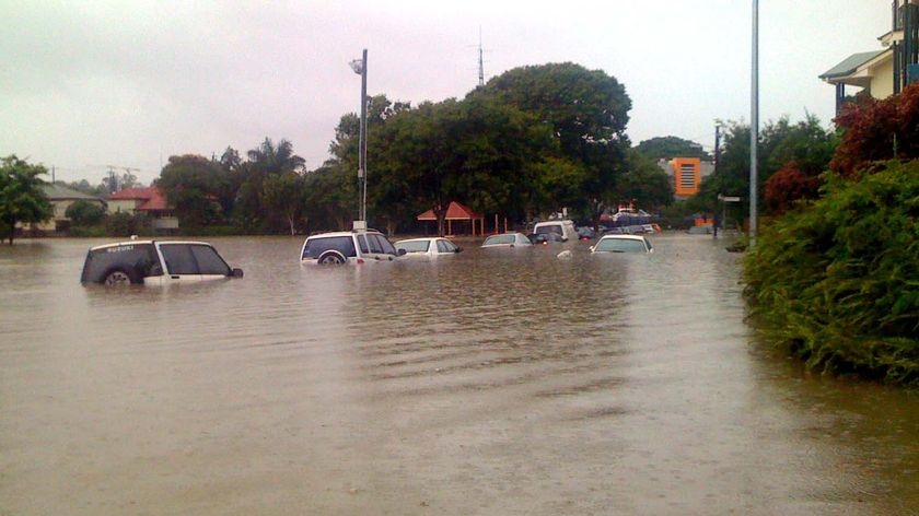 Cars submerged at the end of Fisher Street, East Brisbane yesterday.